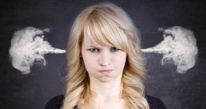 Frustrated woman with steam coming out of her ears